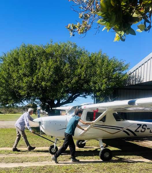 Light aircraft over the Mossel Bay coastline on a learn-to-fly course