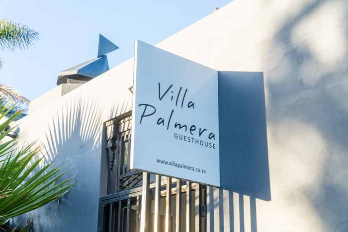 Villa Palmera Guesthouse sign at the entrance